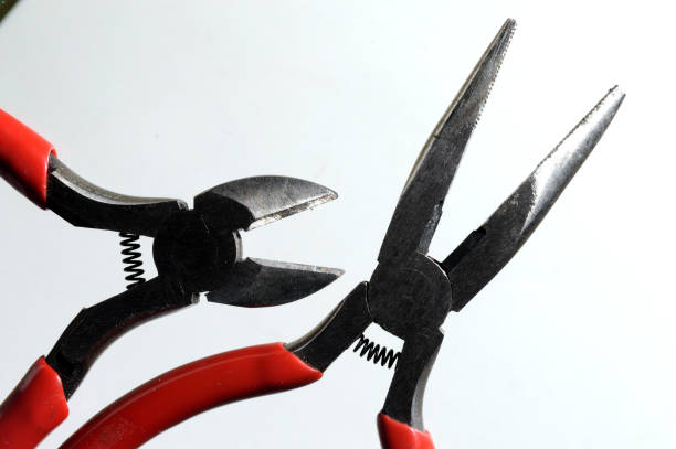 istock nippers and pliers with red handles on a light background close-up. 1362590745
