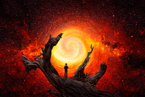istock Man observes the universe on the trunk of a large tree 1362591699