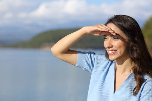istock Woman looking away protecting from sun with hand 1362592839