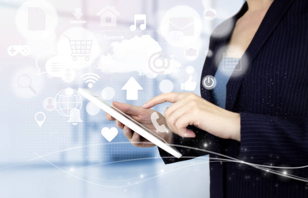 istock Social media or social network notification. Hand touch white tablet with digital hologram social media icons sign on light blurred background. Social media and digital online concept. 1362593137