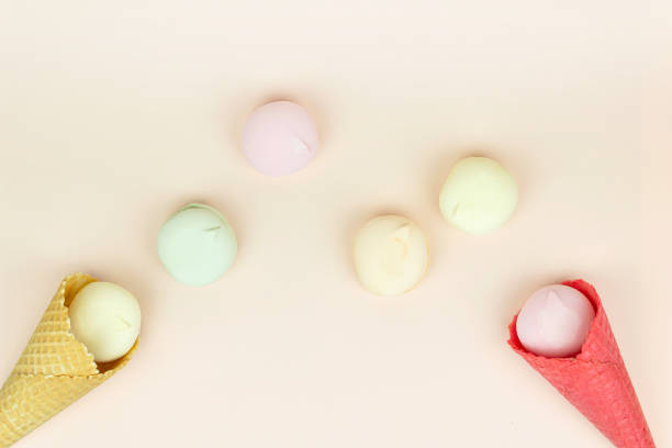 istock Waffle horn with colored marshmallow, looks like macaroons on a pink pastel background. 1362593147