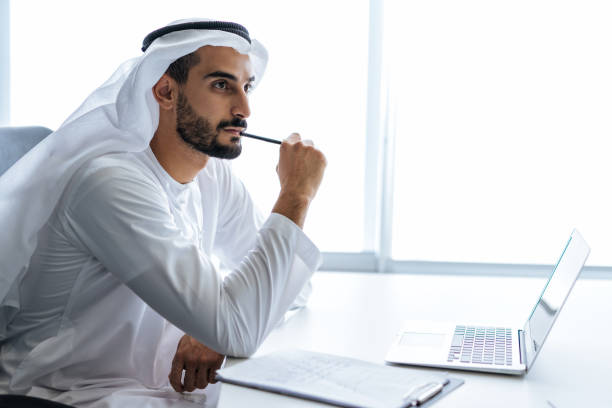 istock Handsome man with dish dasha working in an office of Dubai 1362593889