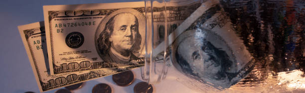 istock Dollar bills in glass jar on the table. Saving money concept. 1362593923