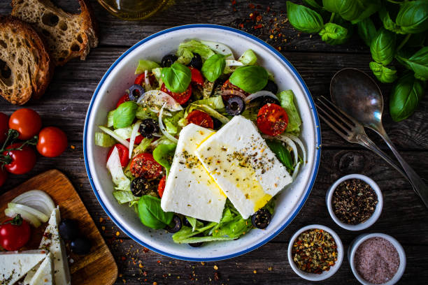 istock Feta cheese salad on wooden table 1362594078
