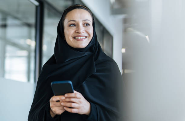 beautiful arabian woman with abaya dress working in the office stock photo