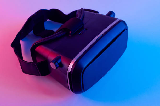 istock Black VR glasses mask on neon color background. Virtual reality headset close up 1362594817