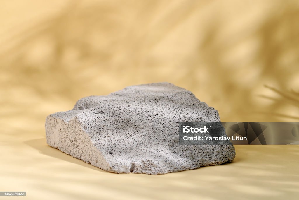 Minimal mockup with premium podium made of natural stone and palm-leaf shadows on the beige background. product pedestal. copy space Minimal mockup with premium podium made of natural stone and palm-leaf shadows on the beige background. product pedestal. Abstract Stock Photo