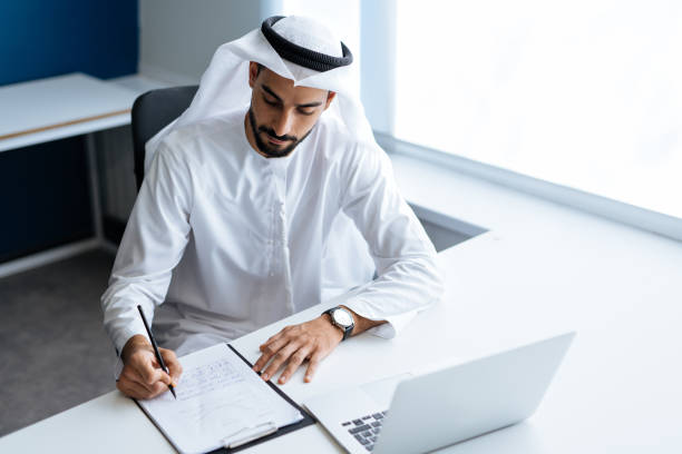istock Handsome man with dish dasha working in an office of Dubai 1362596325