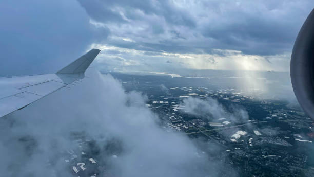 istock View from airplane above clouds and city 1362596714