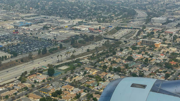 istock View from airplane above clouds and city 1362597413