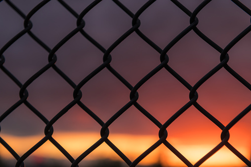 Seattle sunset through a chain-link fence.