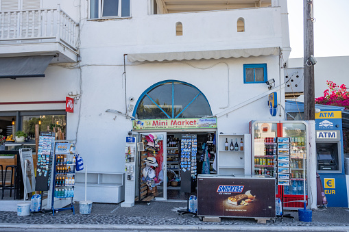 Maria's Mini Market in Pyrgos Kallistis on Santorini in South Aegean Islands, Greece, with an ATM visible as well as a Snickers freezer