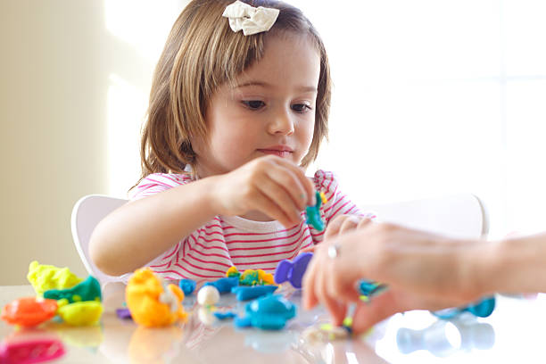 istock Girl playing with play dough 136260763