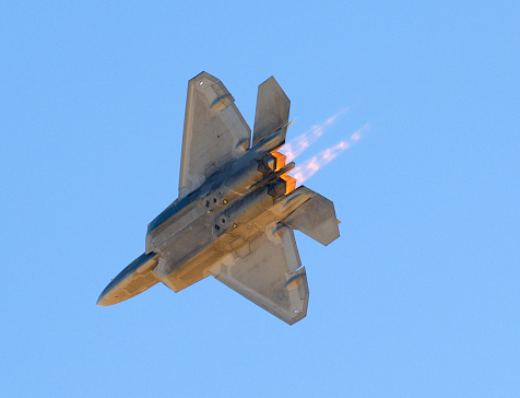 F-22 flyover with full afterburner. Close up shots and underside bomb bay