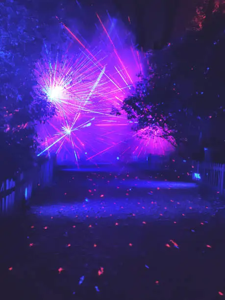 Magical multicoloured laser lights in a footpath in Hampstead Heath park