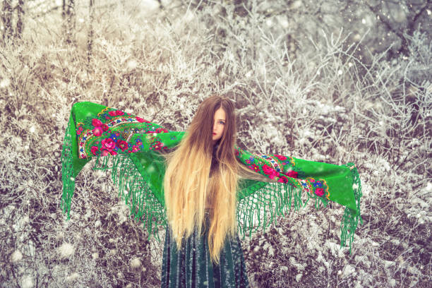 Beautiful blonde posing outdoors in winter forest