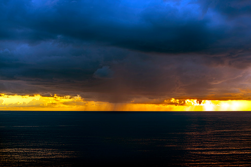The sea and sky covered with rain clouds at sunset
.