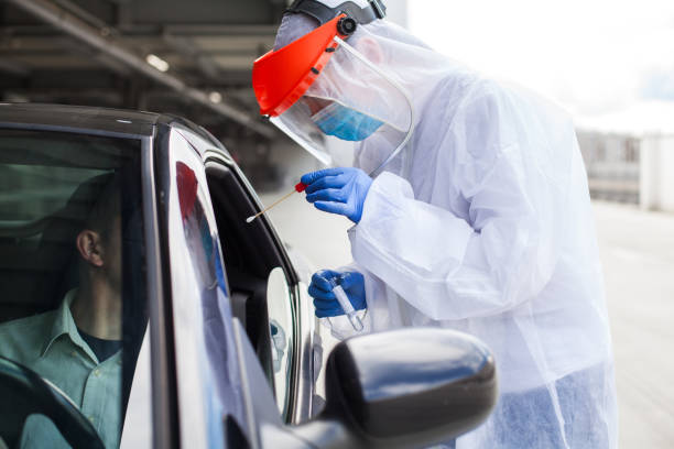 istock Medical worker collecting patient specimen sample in Coronavirus drive through facility 1362609083