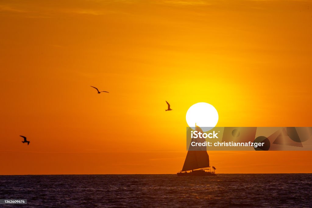 Sunset on Playa Grande, Costa Rica Sailboat on a sunset cruise on the Pacific Ocean off the coast of Costa Rica Sunset Stock Photo
