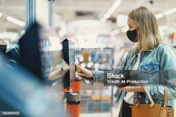 Woman In Medical Mask Pays At Selfcheckouts Stock Photo - Download Image Now - Self Service, Banking, Food