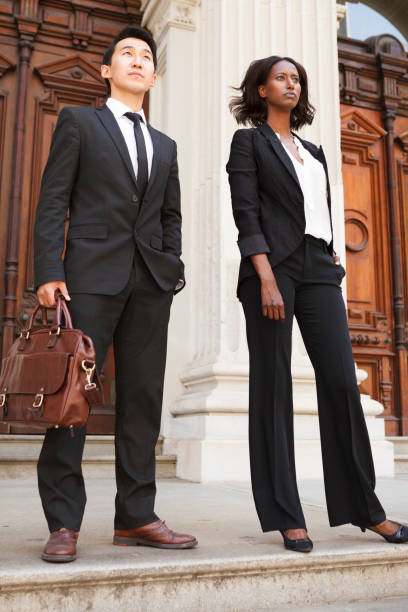 istock Man and Woman on Courthouse Steps Looking Ahead 1362610348
