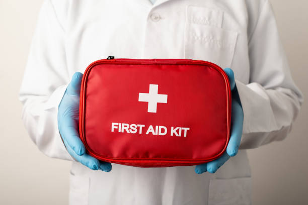 istock Doctor holding red box with inscription First aid kit 1362610419