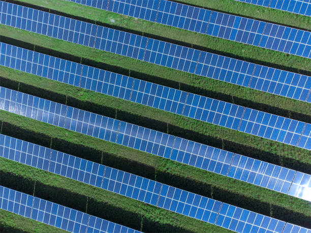 istock Drone view of a solar power plant on a sunny day. Solar farm system with a drone. A source of ecological renewable energy 1362611632