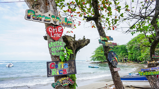 Puerto Viejo, Costa Rica-February 2018: Close up the colourful and old wooden sings on the coastline of Puerto Viejo, a small Carribean coastal town on the southeast of Costa Rica with inspiring sentences and artistic shapes and colours.