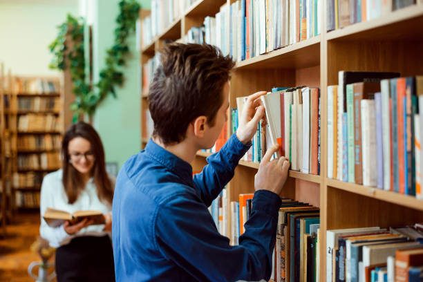 istock Male and female students in the library 1362611805