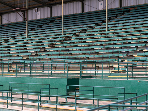 Empty bleacher seats in an old outdoor rodeo arena stadium