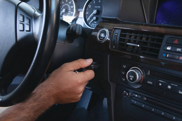 istock a man presses the start button in the car 1362615298