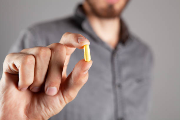 istock holding a capsule in his hand 1362615353