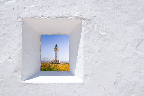 White wall with window in Formentera Formentera mediterranean white window with Barbaria lighthouse beacon photos stock pictures, royalty-free photos & images