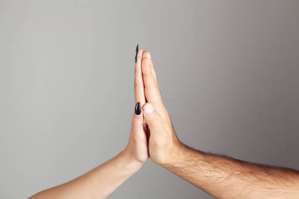 istock man and woman touch with palms 1362615630