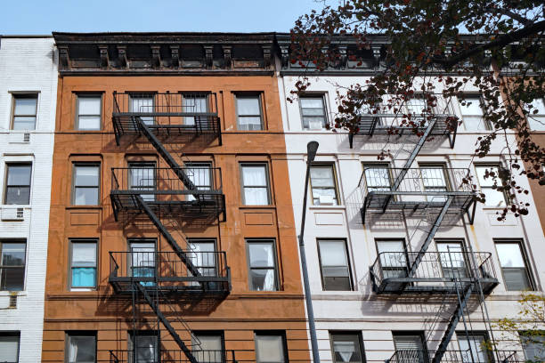 istock Facade of small old-fashioned apartment buildings with external fire escape 1362618021