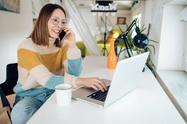 istock Young woman having a call while working at her home office 1362619274