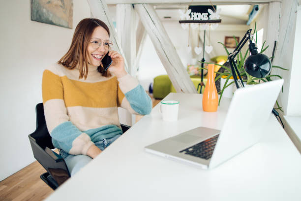 istock Young businesswoman telephoning while working at her home office 1362619280