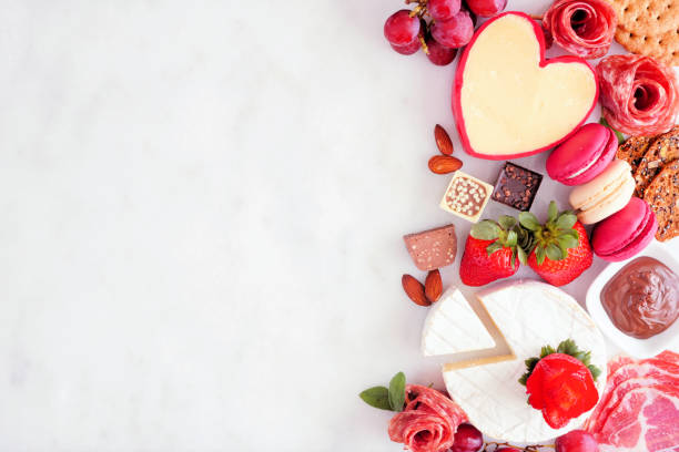 istock Valentines Day charcuterie side border on a white marble background 1362619308