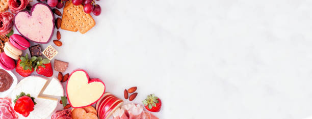 istock Valentines Day charcuterie corner border on a white marble banner background 1362619310