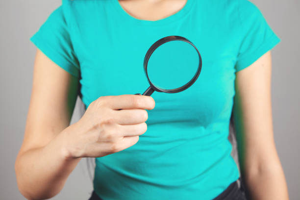 istock woman holding a magnifying glass 1362620129