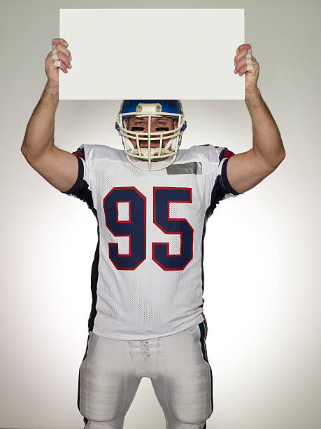 istock American Football Player Holding Empty White Board 136262035