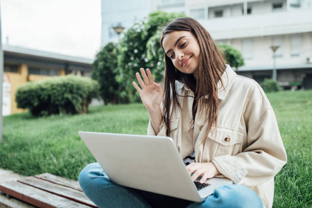 istock Girl sitting outdoors and having an online university class 1362620983
