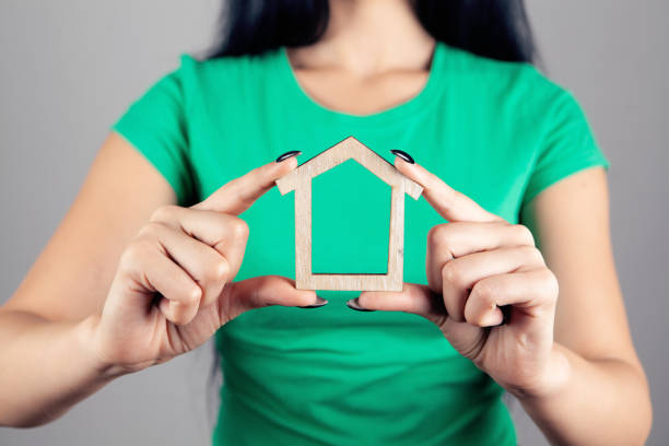 istock Young woman holding house in hands 1362621051