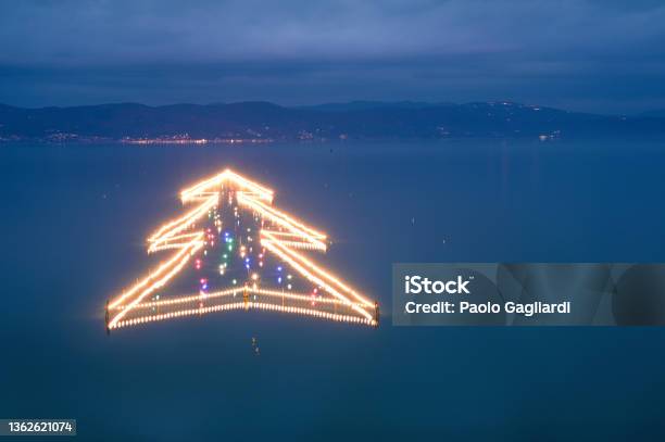Christmas Tree In The Water Castiglione Del Lago Stock Photo - Download Image Now - Christmas, Blue, Christmas Lights