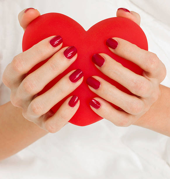 istock Beautiful woman's hands holding big red heart 136262327