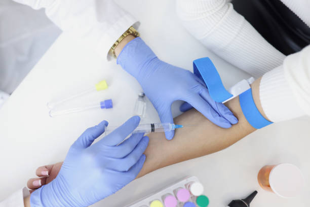 istock Nurse injects liquid medication in womans vein with needle 1362624510