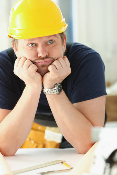 istock Worker man wearing architect hardhat thinking, looking bored and tired at construction site 1362624531