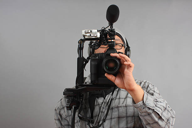 istock Man with HD SLR camera and audio equipment 136262457