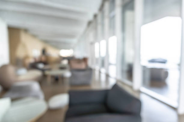 istock Blurred hotel or office building lobby blur background interior view toward reception hall, modern luxury white room space with blurry corridor and building glass wall window 1362624865