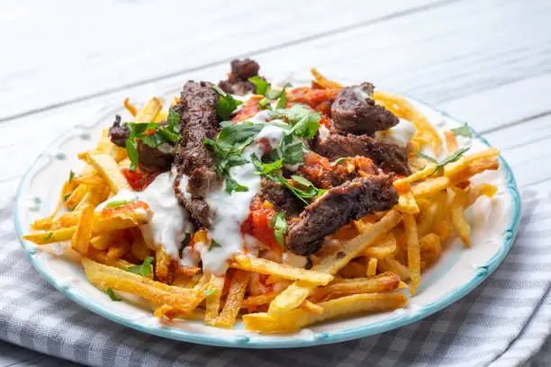 Photo of Turkish food; Cokertme Kebab - Beef meat kebab with yoghurt and french fries